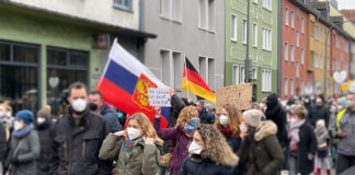 Im Demonstrationszug waren russische Flaggen und mitgeführte Kinder (von uns bewusst unkenntlich gemacht) mitgeführt , Osnabrück, 15.01.2022