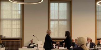 Oberbürgermeisterin Katharina Pötter begrüßt Loreto Bieritz per Handschlag im Stadtrat. / Foto: Guss